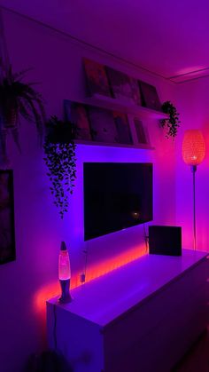 a living room with purple lighting and a flat screen tv