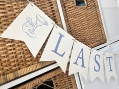 laundry hanging on clothes line next to wicker basket with laundry sign and laundry hamper