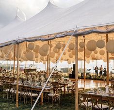 a large tent set up with tables and chairs