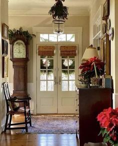 the hallway is decorated for christmas with poinsettis and wreaths on the door