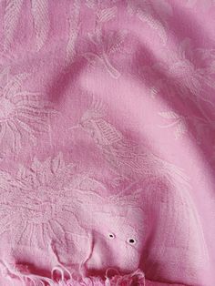 a pink blanket with white flowers on it