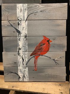 a painting of a red cardinal perched on a branch in front of a white birch tree