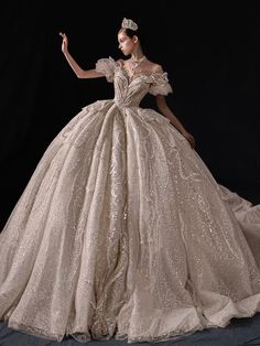 a woman in a ball gown is posing for the camera with her hand on her hip