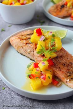 salmon with pineapple salsa on a white plate