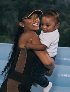 a woman holding a baby in her arms