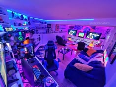 a living room filled with lots of furniture and gaming equipment