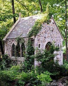 an old stone house surrounded by greenery and trees