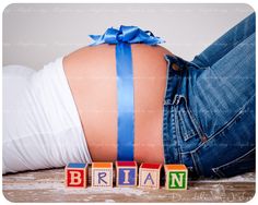 the back of a woman's stomach with blocks spelling britain and blue ribbon on it