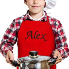 a young boy wearing an apron and holding a pot with the word alex on it