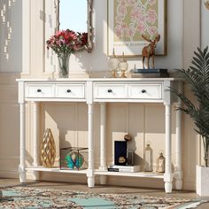 a white console table with two drawers and flowers in vases on the top shelf