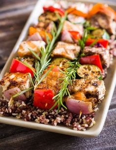 a plate with chicken, rice and vegetables on it