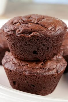 three chocolate muffins stacked on top of each other