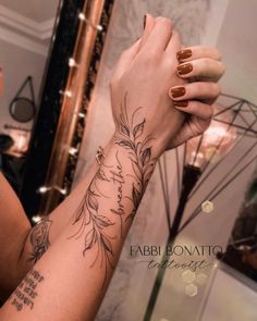 a woman's arm with flowers on it