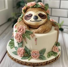 a decorated cake with a slotty on it's face and flowers around the edges