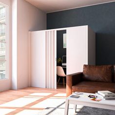 a living room filled with furniture next to a window and a white table in front of it