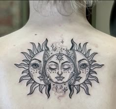 a woman's back with sun and moon tattoos on her upper body, which is covered in black ink