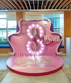 a pink and white sign that says happy women's day