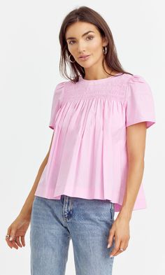 Cotton yoke blouse designed with short sleeves and pleated texture. Easy to style with any bottoms. Top Bubblegum pink Self: 100% Cotton Length: 23" Chest: 17 3/4" Hand wash in cold water. Lay flat to dry. Low iron. Model is wearing a size small Style #: G242T6942 Pink Cotton Smocked Top For Summer, Feminine Pink Tops With Smocked Back, Summer Short Sleeve Blouse With Smocked Bodice, Summer Short Sleeve Blouse With Smocked Cuffs, Summer Blouse With Smocked Cuffs And Short Sleeves, Summer Short Sleeve Smocked Top, Cotton Smocked Short Sleeve Top For Daywear, Cotton Smocked Top With Short Sleeves For Daywear, Pink Blouse With Smocked Cuffs For Summer