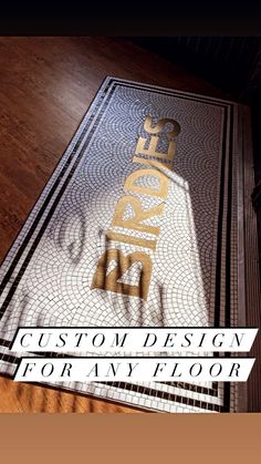 a book with the words custom design for any floor in gold and silver on it