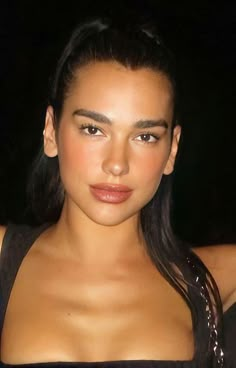 a close up of a person wearing a black top