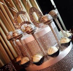 a three tiered cake with cupcakes on top