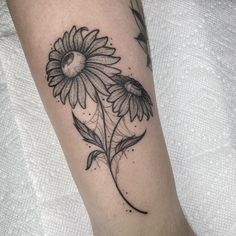 a black and white photo of a sunflower tattoo