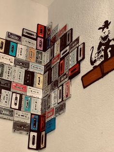 a bunch of cassettes are arranged in the shape of a heart on a wall