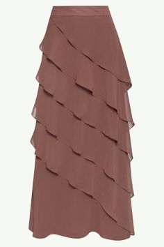 Indulge in luxury with the Tasnima Tiered Chiffon Maxi Skirt in Taupe. This elegant maxi skirt boasts a delicate tiered ruffle design, adding a touch of sophistication to any outfit. Made from lightweight chiffon, it flows gracefully with every step. Elevate your wardrobe with this exclusive piece. Model is 5'7 wearing size XS.