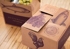 two brown boxes with different types of food on top of wooden floor next to each other