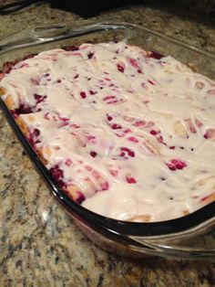 a casserole dish with cranberry sauce and white icing on top