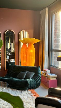 a living room filled with furniture next to a window