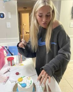 a woman cutting a cake with a knife