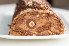 a close up of a piece of chocolate cake on a plate with peanut butter in the middle