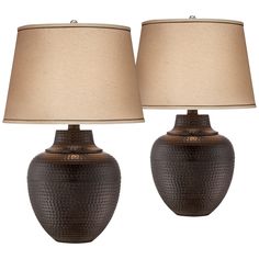 two lamps are sitting next to each other on a white background, one is brown and the other is beige