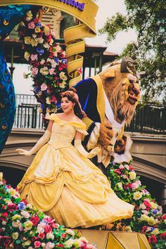 the beauty and the beast float is decorated with flowers, roses, and other decorations