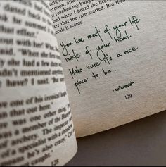 an open book with writing on it and a handwritten poem in green ink next to the opened book