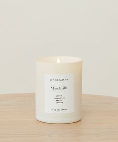 a white candle sitting on top of a wooden table