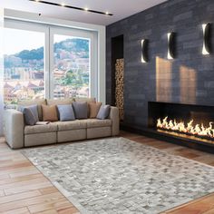 a living room with a couch, fireplace and large glass doors that look out onto the city