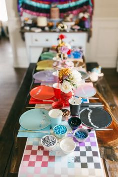 a long table with plates and bowls on it