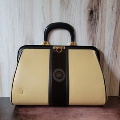 "An Italian designer leather and velvet top-handle bag. Fabulous block stripe design with a kiss-lock closure at the top and a single large rounded handle. Polished black leather for the handle and trim. A subtle matte camel leather for the body and a chocolate brown velvet stripe. Gold-tone hardware. Gold \"R\" initial. Black leather lining with two interior pockets. Excellent condition, no damage found. Minor scuffs and signs of use will be found. Some of the photos show the leather to look a soft dijon mustard shade, it is not, it is a true camel colored leather. Dimensions: L:16\" x H:10\" x W:4\", handle drop 4\" To see all our sale jewelry go to the home page or use the address below and choose the section titled Jewelry. www.tinglazesandglass.etsy.com Follow us on Facebook and Insta R Initial, Brown Velvet, China Art, Velvet Top, Italian Designer, Colored Leather, Camel Color, Velvet Tops, Dijon Mustard