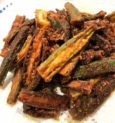 fried green beans on a plate with seasoning