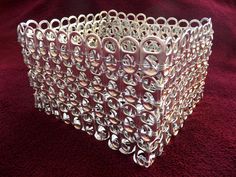 a clear glass vase sitting on top of a red cloth