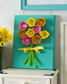 a bouquet of flowers sitting on top of a dresser