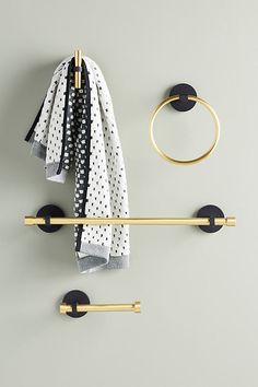 a towel rack with two hooks and a scarf hanging on the wall next to it