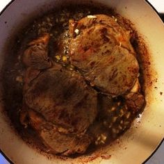 a pot filled with meat and vegetables on top of a stove