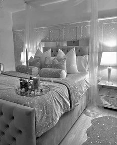 black and white photograph of a bedroom with stars on the bed, chandelier