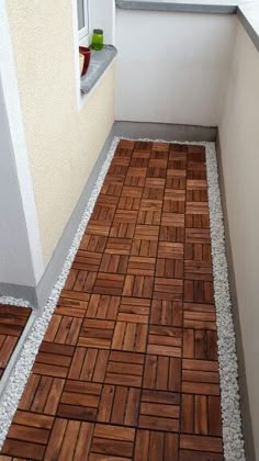 the floor is made out of wood planks and has been laid on top of it