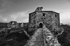 black and white photograph of an old stone building