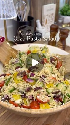 a large bowl filled with salad on top of a wooden table