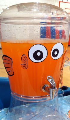 an orange drink in a large glass with eyes